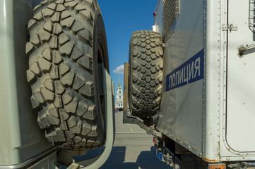 Two russian police trucks closing way to square 