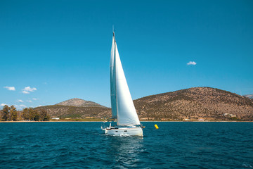 Fototapeta na wymiar Sailboat in the sea. Сruise sailing.