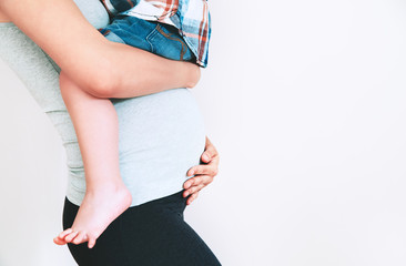 Pregnant mother and son at home.