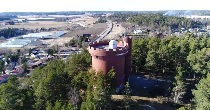 Halikko watertower, Cinema 4k landing tilt view aerial of Halikko water tower, on a sunny spring day, in Salo, Finland