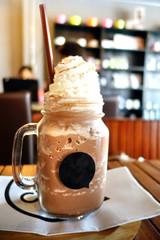 Ice chocolate or cocoa with whipped cream in cafe.