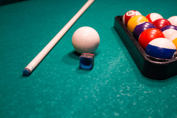 Billiard balls near by cue and chalk