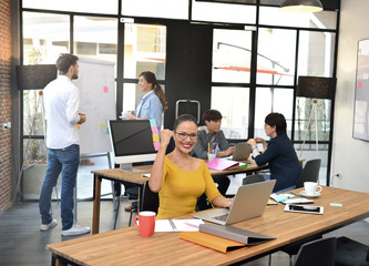 Senior businesswoman smiling at camera in office environment