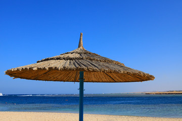 Beach parasol in Port Ghalib, a beautiful port, marina and tourist town near Marsa Alam, Egypt.