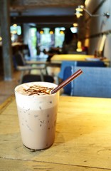 Ice chocolate or cocoa with whipped cream in cafe.