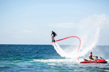 Silhouette of a fly board rider at sea
