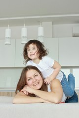 Happy loving family. Mother and her daughter child girl playing and hugging.