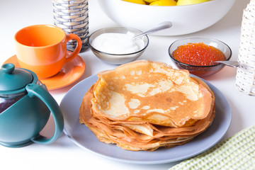 Traditional Russian pancakes with caviar and sour cream. Maslennitsa. Selective focus