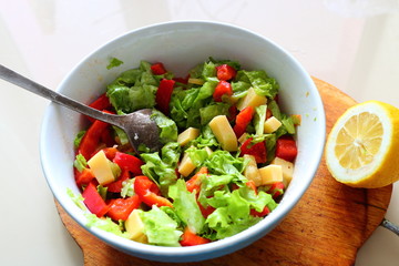 Salad sweet red pepper, leafs green salad and cheese with sauce of lemon and olive oil