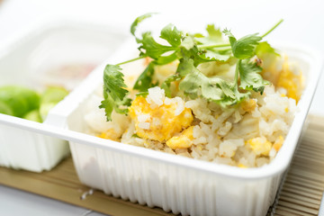 Fried rice in plastic box on White background