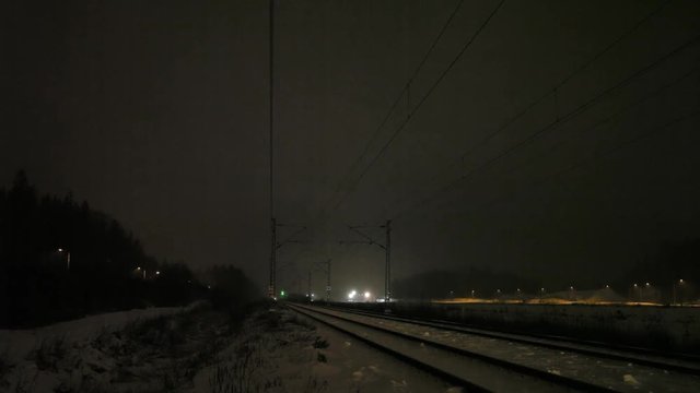 Passenger train on a snowy night