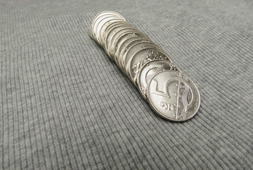 5 CZK coins over fabric surface