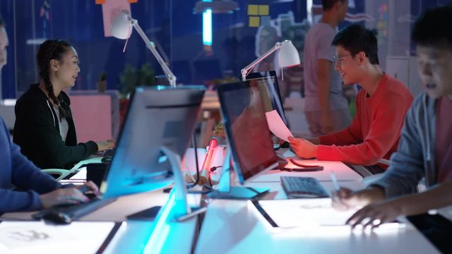  Young Asian video game developers working together on a project