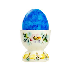 Blue Easter egg in a porcelain holder isolated on white background