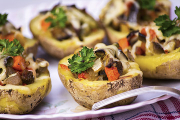 Baked potatoes stuffed with vegetables and cheese