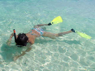 Tanned girl in fins and mask