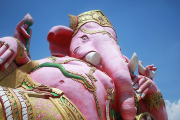 close-up ancient carving of clining peace Ganesha god, god of successful with blue clear sky...