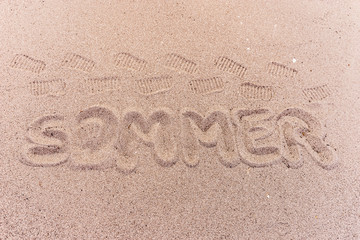 Word summer (Sommer) in german written on the beach