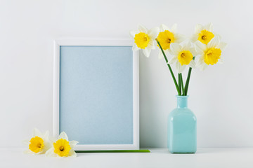 Mockup of picture frame decorated daffodil flowers in vase with clean space for text your blogging and greeting for mother day.