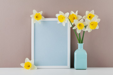 Mockup of picture frame decorated narcissus flowers in vase with clean space for text your blogging and greeting for mother day.