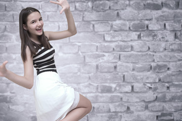 young and happy teenager in black and white dress