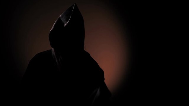 Grim girl in a ritual wardrobe with a knife in a dark