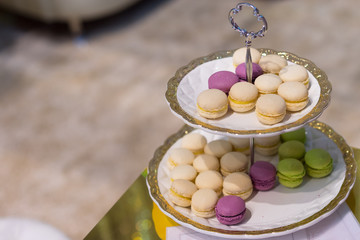 Macaroons on plates closeup