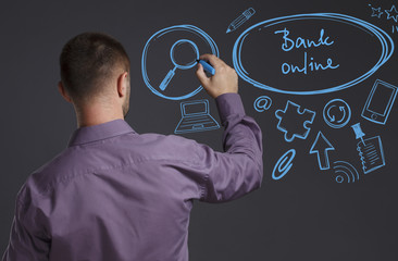Business, Technology, Internet and network concept. A young businessman writes on the blackboard the word: Bank online