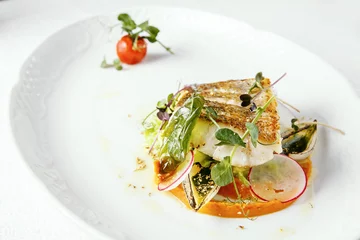 Photo sur Plexiglas Plats de repas Fish dish - fried fish fillet of zander served with tomato, Radish and milk sauce