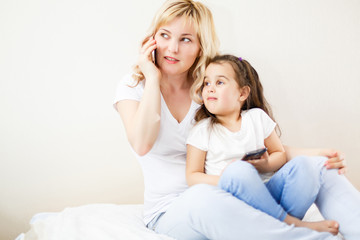 Indian mother and child playing game on the smartphone