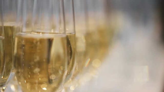 close up refocusing shot of many glasses of champagne on the table