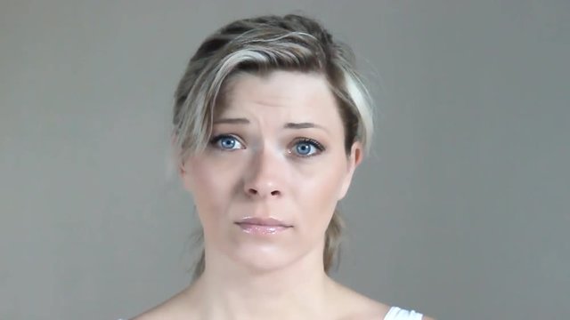 Blue-eyed blonde cute girl asks for forgiveness showing entreaty gesture