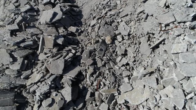 Aerial top-down view of debris also known as rubble wreckage ruins or scattered remains of destroyed building showing concrete parts piled up and not used anymore perfect concrete rubble background