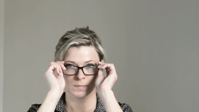 Beautiful woman with bad eyesight uses glasses