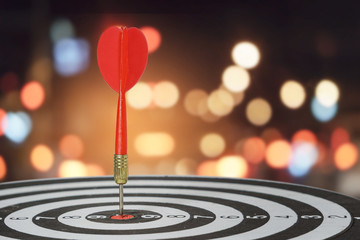 Fototapeta premium target dart with arrow over blurred bokeh background ,metaphor to target marketing or target arrow concept.
