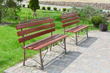 Two benches on the pavement.