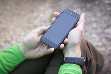 Man hand holding contemporary modern smartphone. Blank display replaceable with needed design.Vertical. Portrait mode mockup.