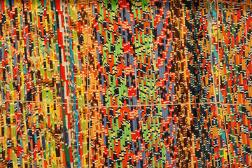 background, texture of colored handmade carpet. Fabric rug of small patches