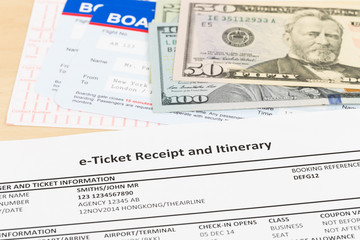 E-ticket, dollar money banknote, and boarding pass;  these documents are mock-up