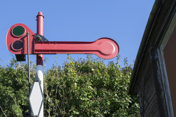 Historic red Dutch railway signal post.