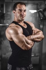 Fototapeta na wymiar Brutal strong athletic men pumping up muscles train in gym