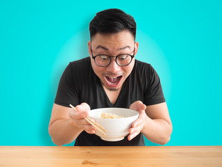 Funny surprised face man eatting instant noodles.