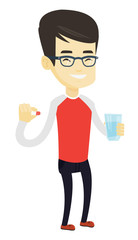 Young asian man taking pills.