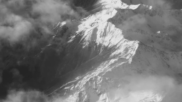 Vintage Black And White Aerial View of Clouds and Snow Covered Alps Mountains