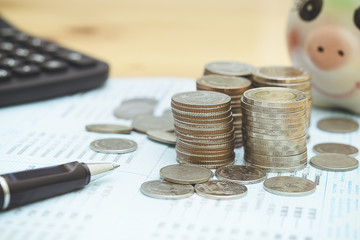 Row of coins,calculator with account book finance and banking concept for background.Concept in grow and walk step by step for success in business. concept of saving money.select focus