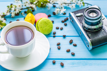 Stil life with macarons and coffee on the wooden background