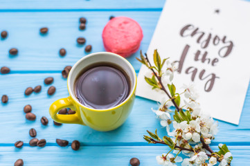 Stil life with macarons and coffee on the wooden background