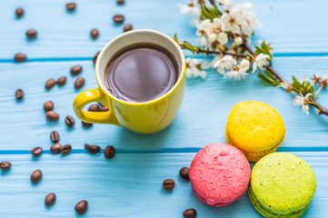 Stil life with macarons and coffee on the wooden background