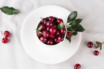 Fresh cherries in bowl on table