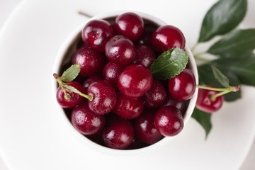 Fresh cherries in bowl on table